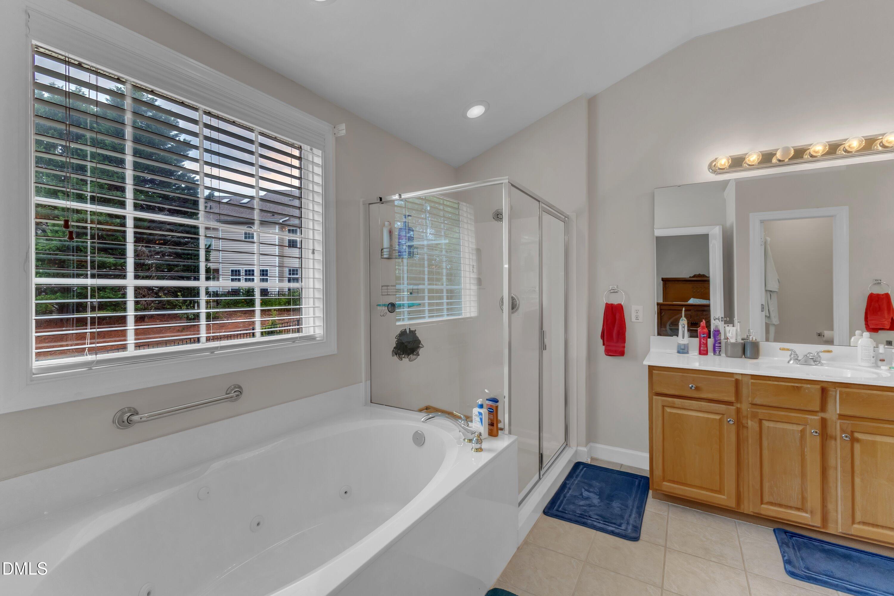12227 Orchardgrass Lane Raleigh, NC 27614 - Photo 37 of 46 a bathroom with a bathtub and a sink