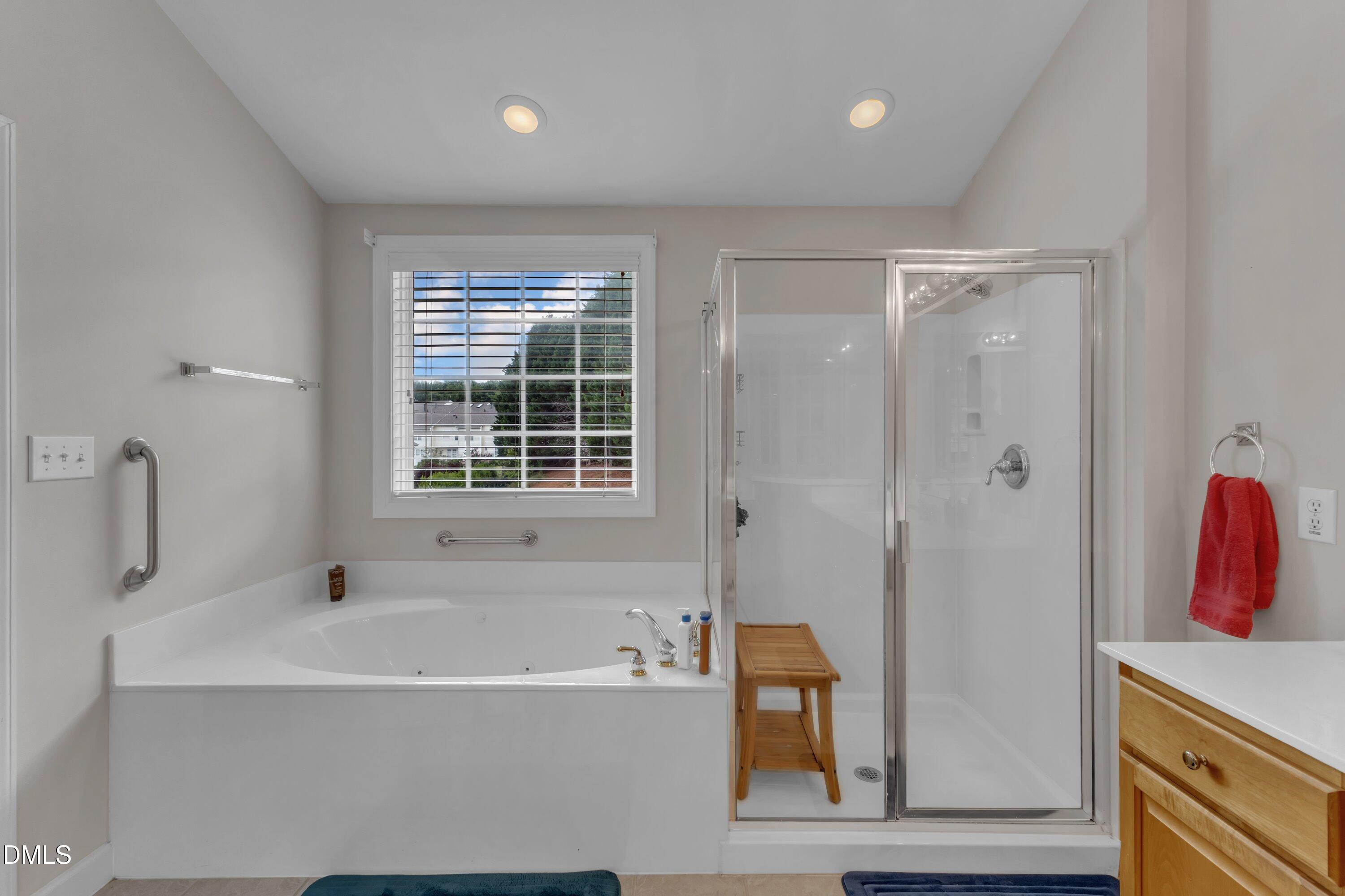 12227 Orchardgrass Lane Raleigh, NC 27614 - Photo 39 of 46 a bathroom with a tub and shower