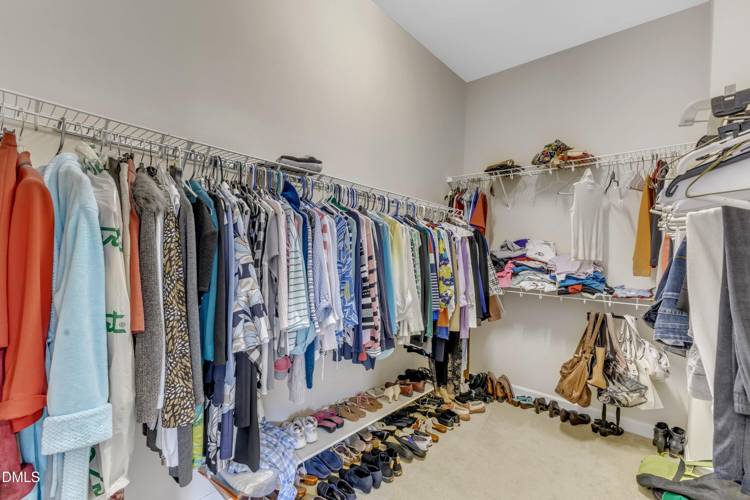 12227 Orchardgrass Lane Raleigh, NC 27614 - Photo 40 of 46 a view of walk in closet with clothes