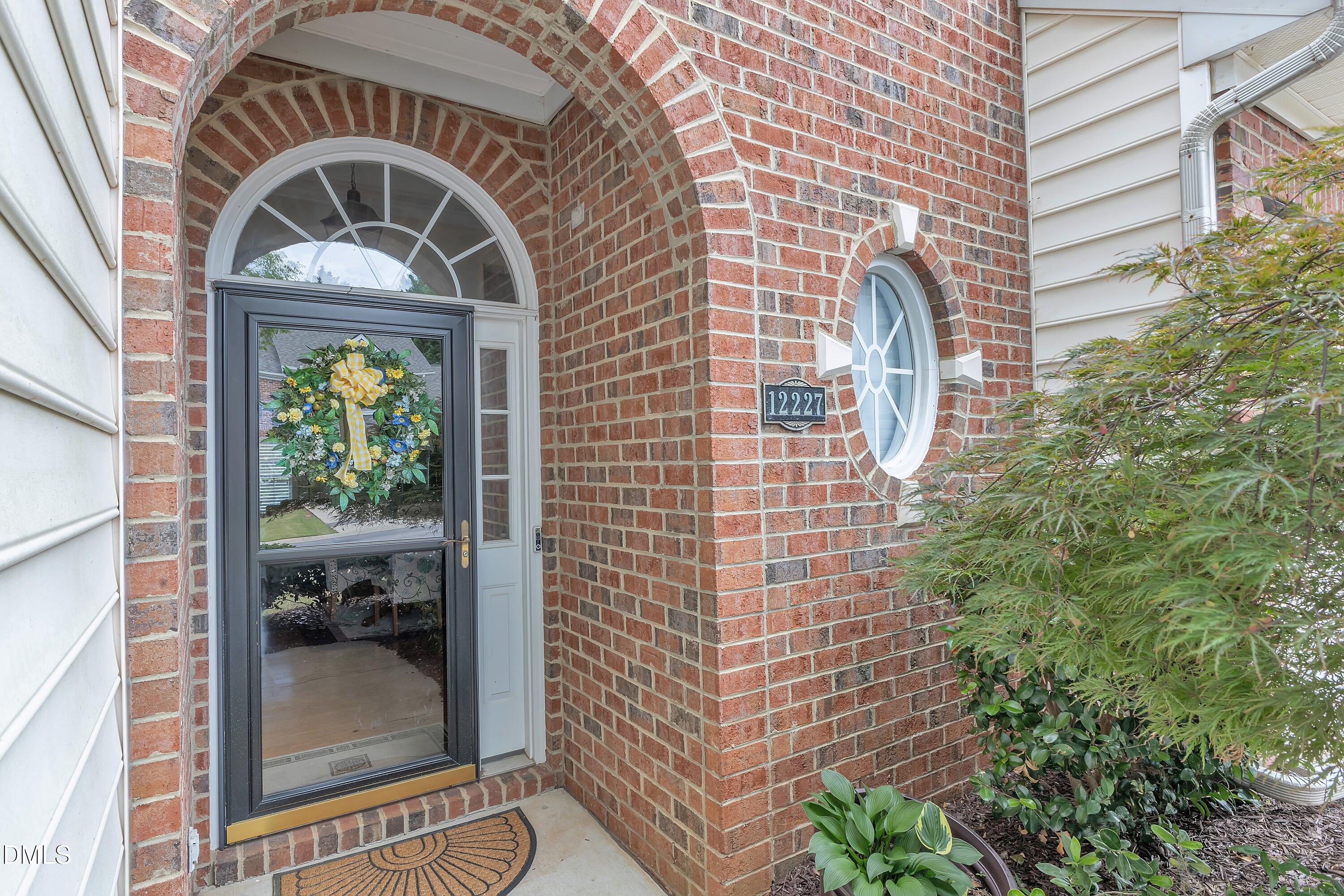 12227 Orchardgrass Lane Raleigh, NC 27614 - Photo 4 of 46 a view of a door with a brick wall