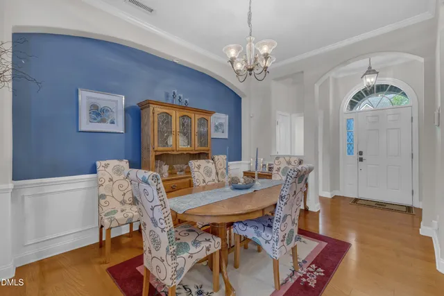 a view of a dining room with furniture and chandelier