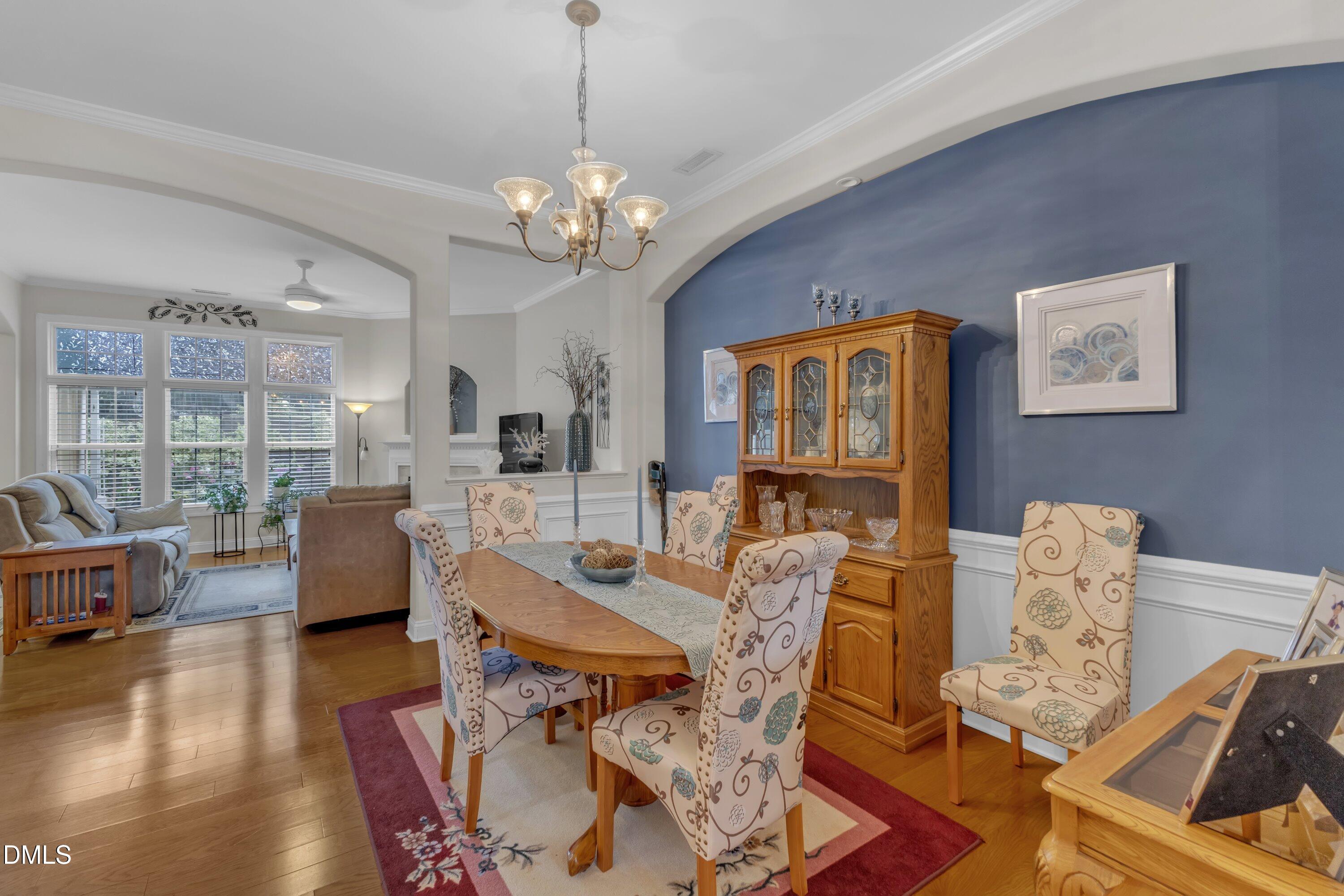 12227 Orchardgrass Lane Raleigh, NC 27614 - Photo 9 of 46 a living room with fireplace furniture and a chandelier
