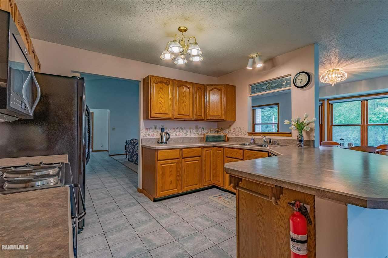16867 Hartman Road Davis, IL 61019 - Photo 8 of 39 a kitchen with stainless steel appliances granite countertop a sink a stove counter space and cabinets