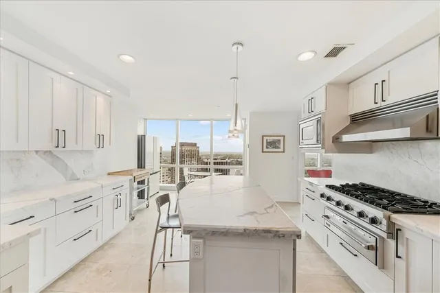 a kitchen with white cabinets and appliances