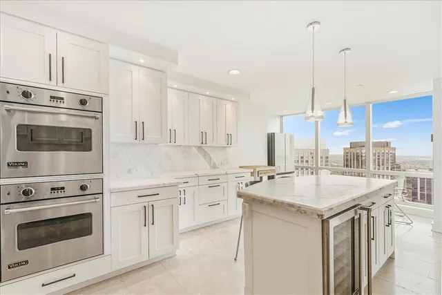 a kitchen with appliances a sink and cabinets