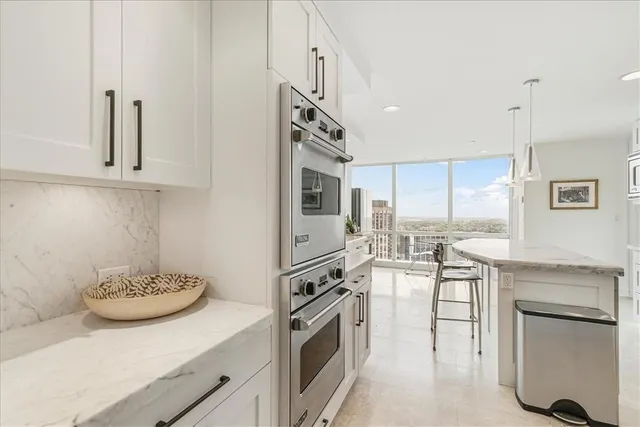 a kitchen with cabinets and stainless steel appliances