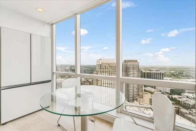 a balcony with furniture and a floor to ceiling window