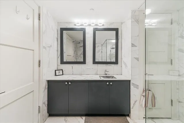 a bathroom with a double vanity sink and a mirror