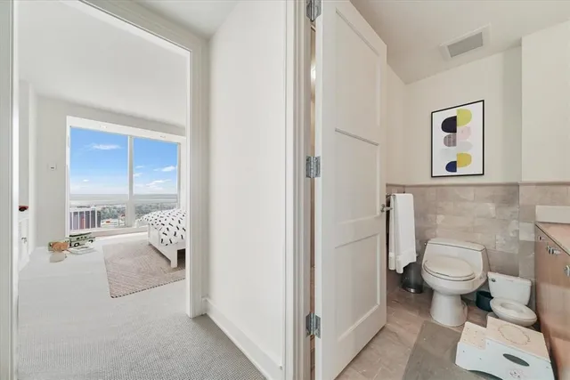 a bathroom with a toilet and a shower