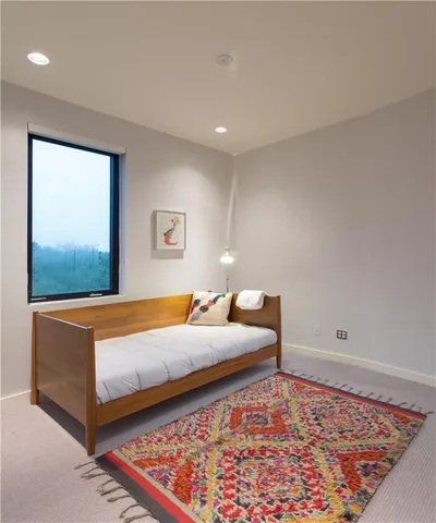 a bedroom with a bed and window