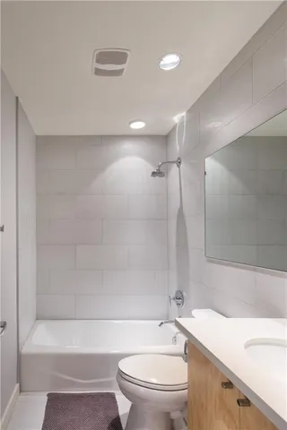 a bathroom with a toilet a sink and a bathtub