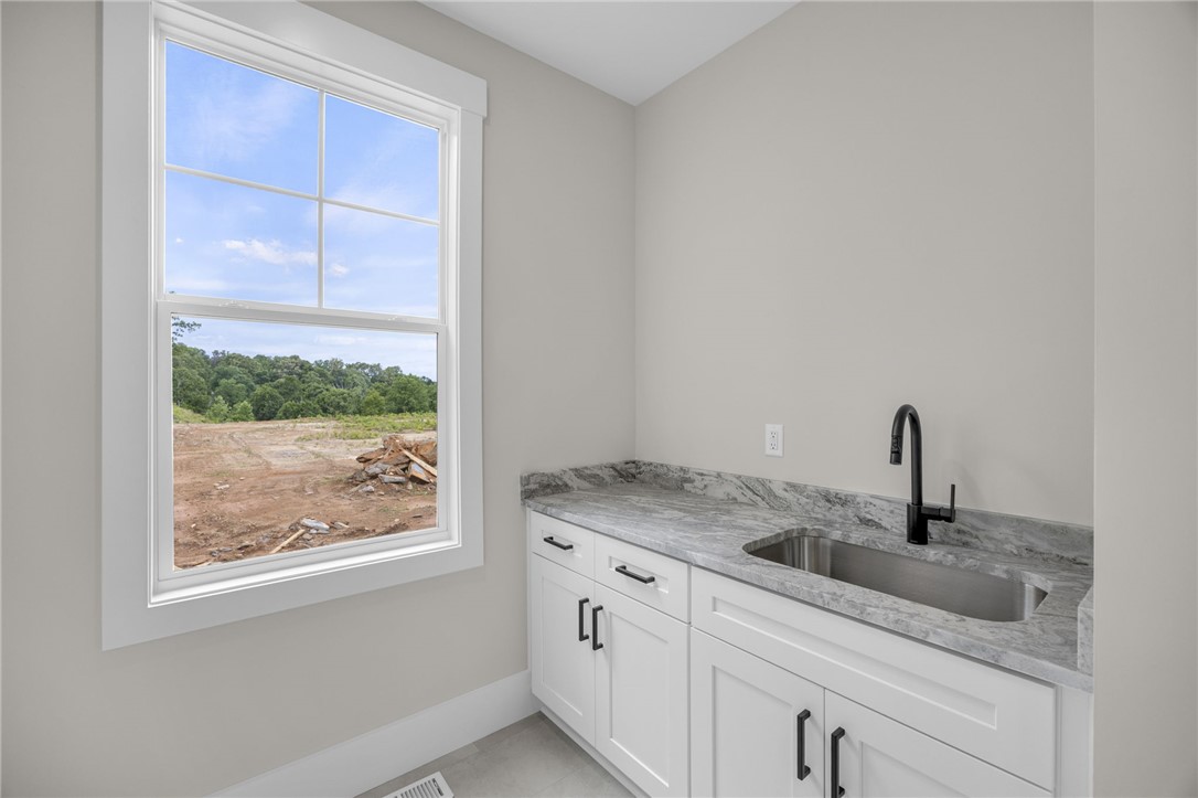1230 Melton Road, Unit 216 West Union, SC 29696 - Photo 15 of 49 A window-lit utility space provides essential function with a modern sink and durable countertops.
