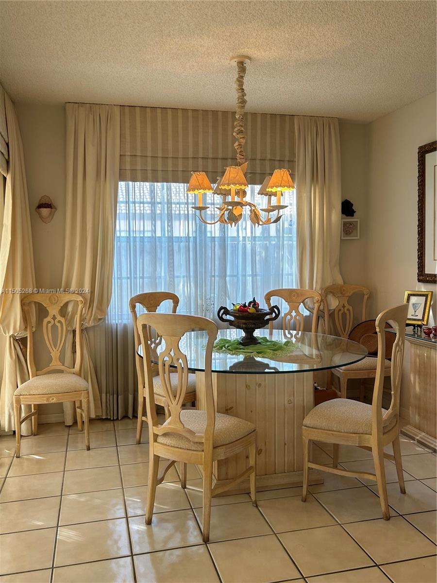19232 Northwest 88th Place Hialeah, FL 33018 - Photo 15 of 61 a view of a dining room with furniture