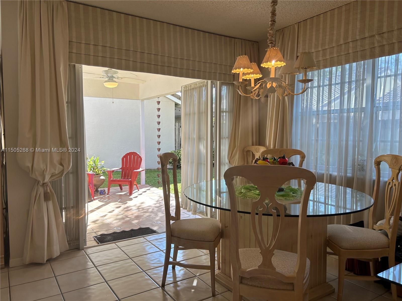 19232 Northwest 88th Place Hialeah, FL 33018 - Photo 16 of 61 a view of a dining room with furniture and chandelier