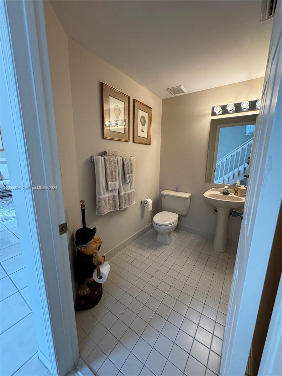19232 Northwest 88th Place Hialeah, FL 33018 - Photo 28 of 61 a living room with furniture and a toilet