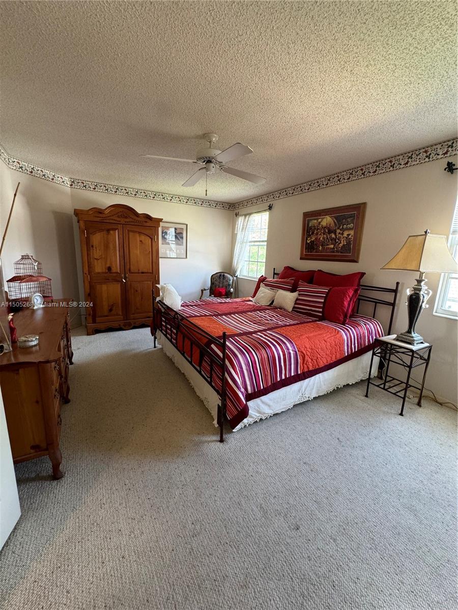 19232 Northwest 88th Place Hialeah, FL 33018 - Photo 30 of 61 a spacious bedroom with a bed and a cabinets