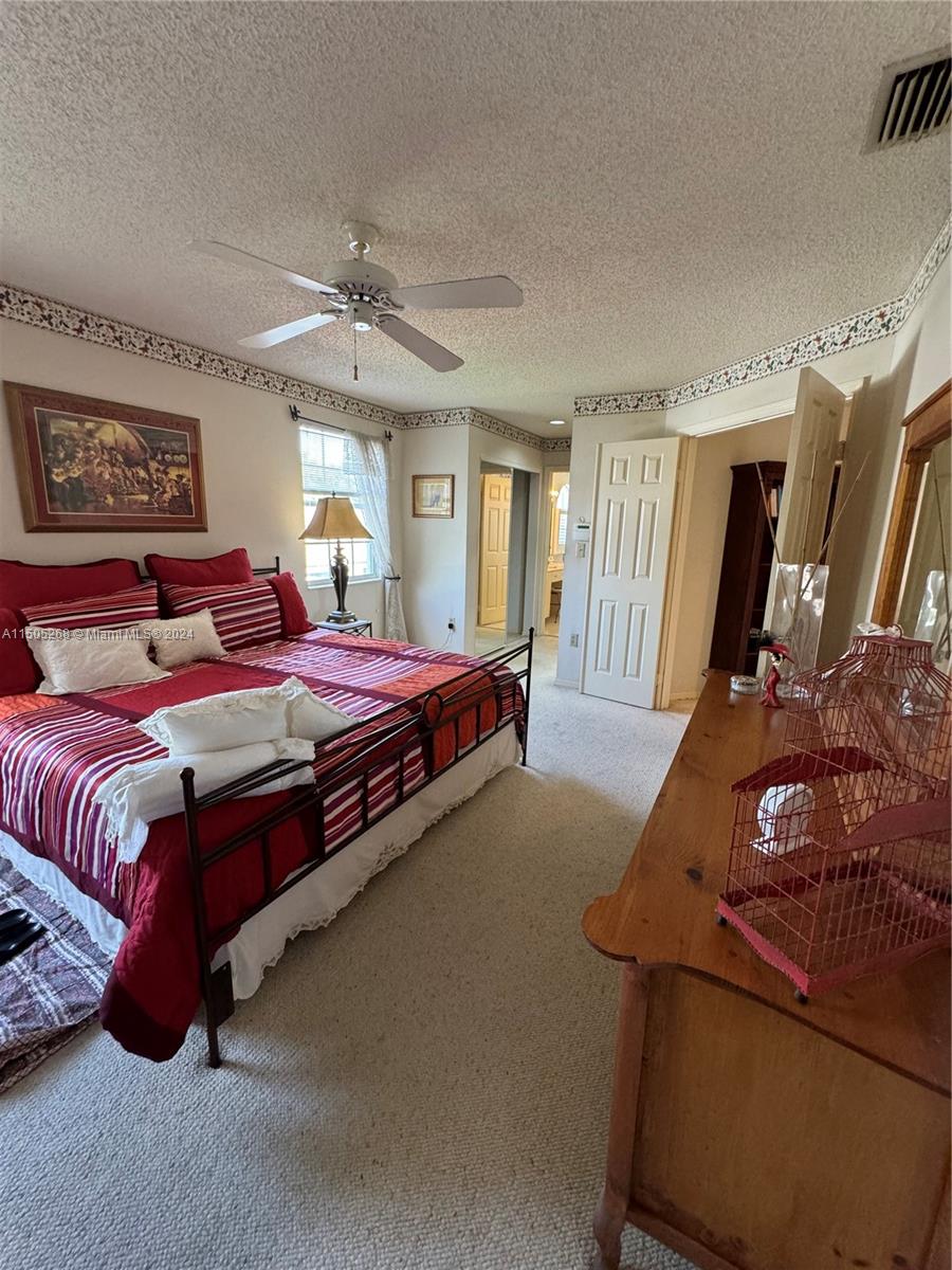 19232 Northwest 88th Place Hialeah, FL 33018 - Photo 31 of 61 a spacious bedroom with a bed window and dresser