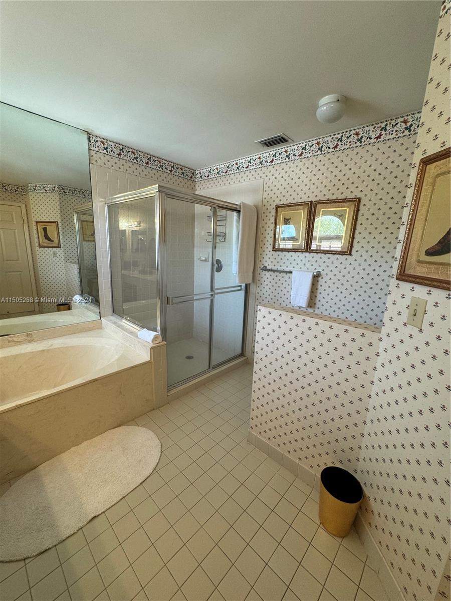 19232 Northwest 88th Place Hialeah, FL 33018 - Photo 36 of 61 a spacious bathroom with a granite countertop sink a toilet and mirror
