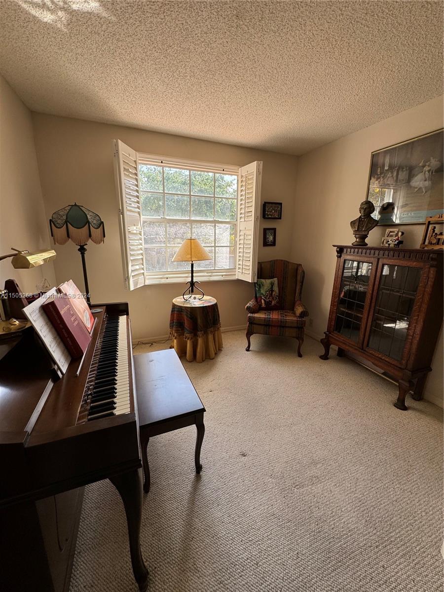 19232 Northwest 88th Place Hialeah, FL 33018 - Photo 50 of 61 a living room with furniture and a window