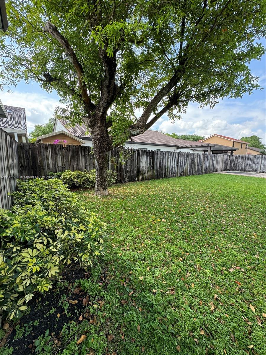 19232 Northwest 88th Place Hialeah, FL 33018 - Photo 58 of 61 a view of a house with a yard and large trees