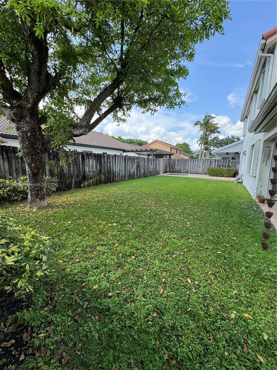 19232 Northwest 88th Place Hialeah, FL 33018 - Photo 60 of 61 a view of a big yard with plants and large trees