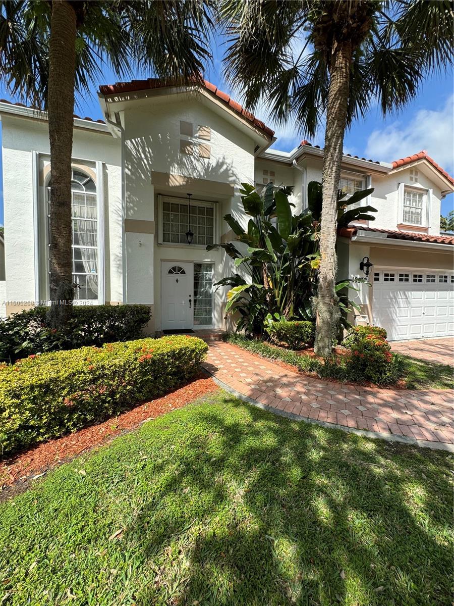 19232 Northwest 88th Place Hialeah, FL 33018 - Photo 6 of 61 a front view of a house with garden