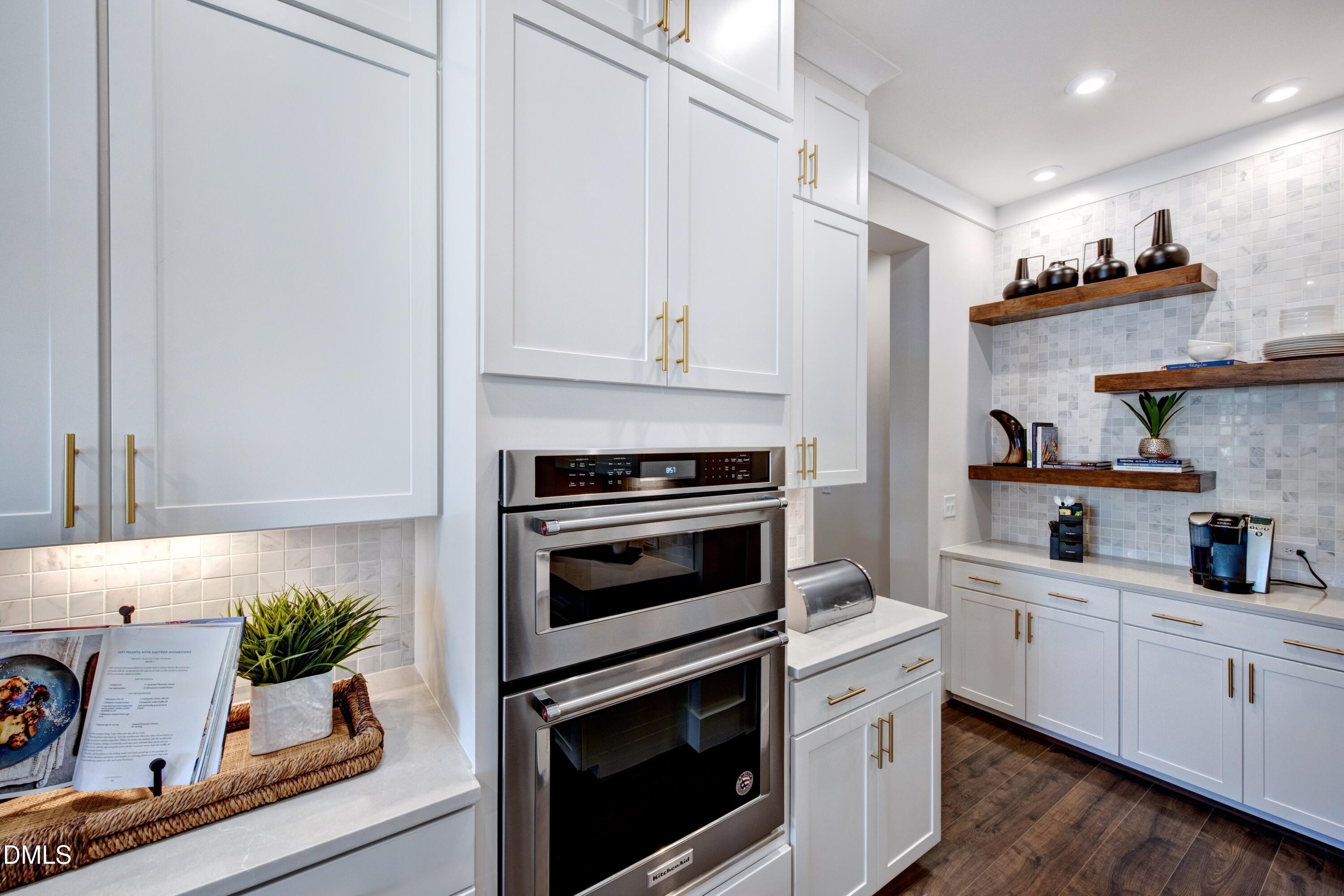 3 Wolf Tree Way Efland, NC 27243 - Photo 9 of 32 a kitchen with stainless steel appliances white cabinets and a stove top oven
