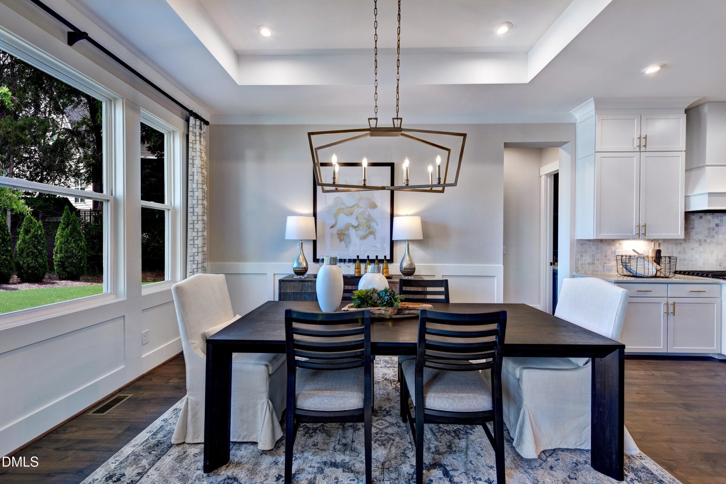 3 Wolf Tree Way Efland, NC 27243 - Photo 11 of 32 a view of a dining room with furniture window and wooden floor