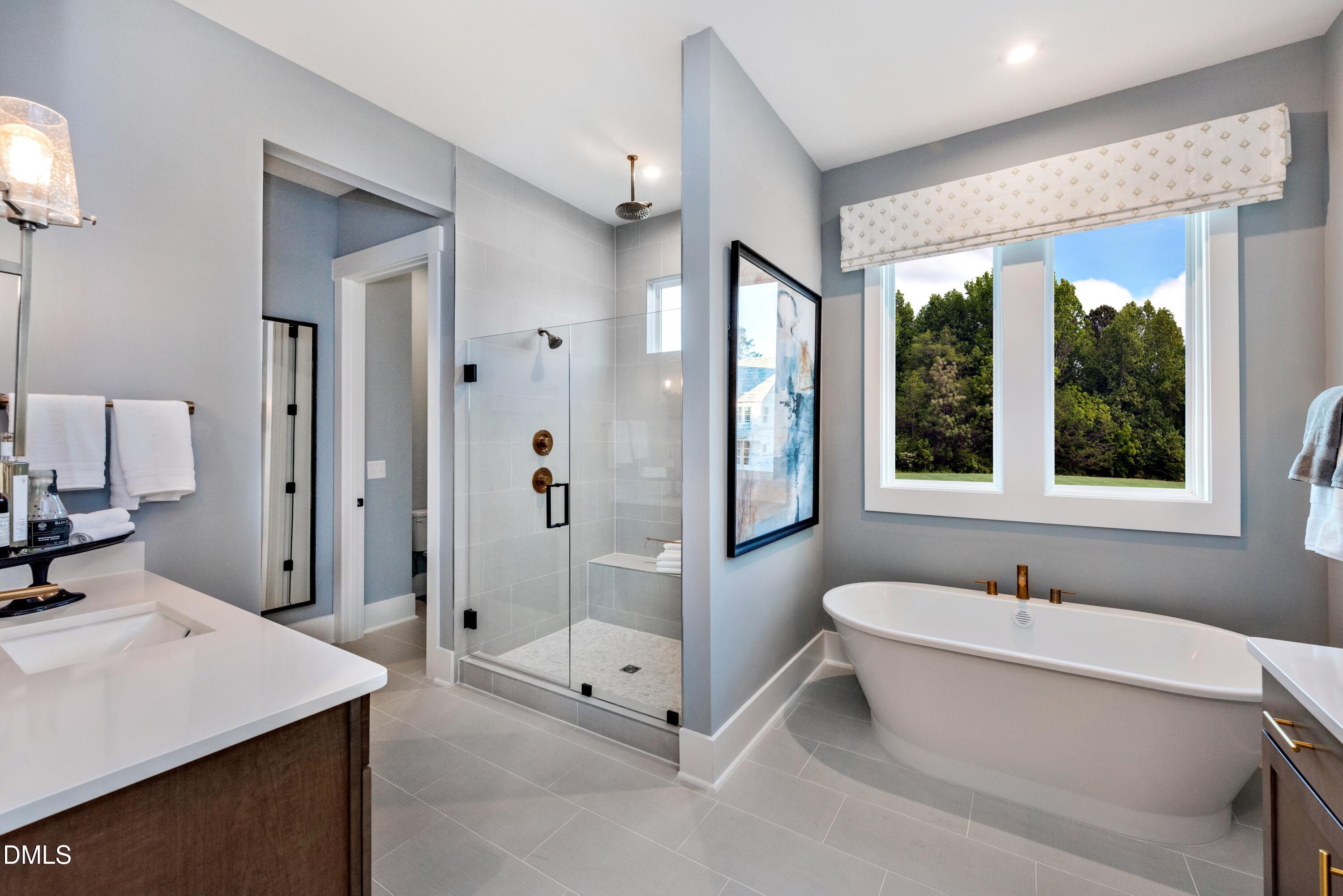 3 Wolf Tree Way Efland, NC 27243 - Photo 16 of 32 a bathroom with a tub sink shower and mirror