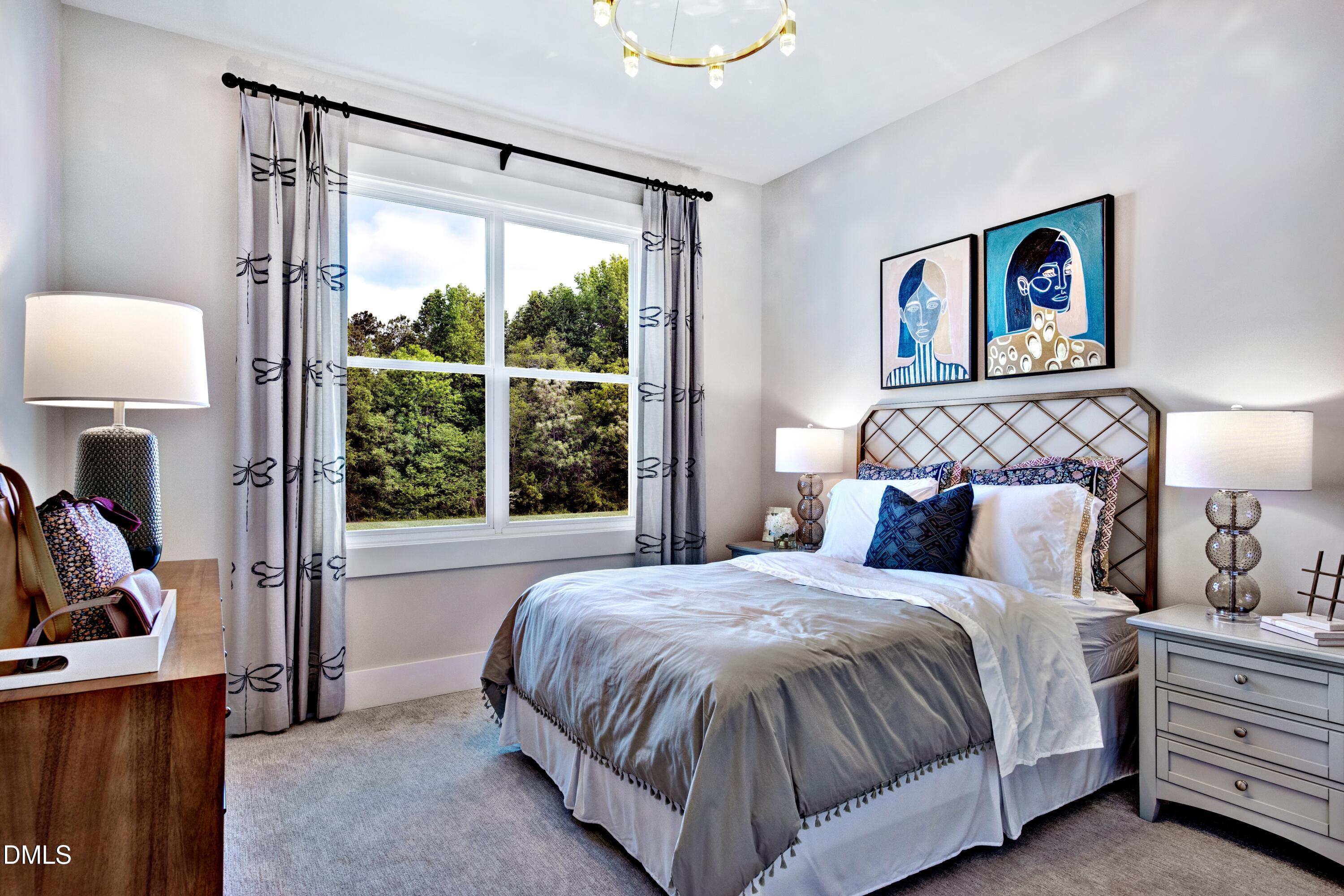 3 Wolf Tree Way Efland, NC 27243 - Photo 18 of 32 a bedroom with a bed and a large window