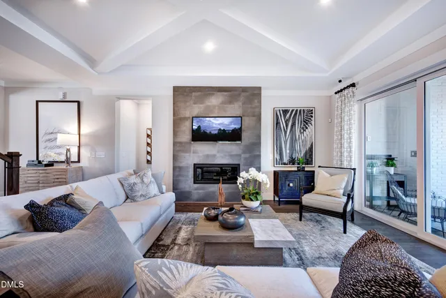 a view of a livingroom with furniture wooden floor a chandelier