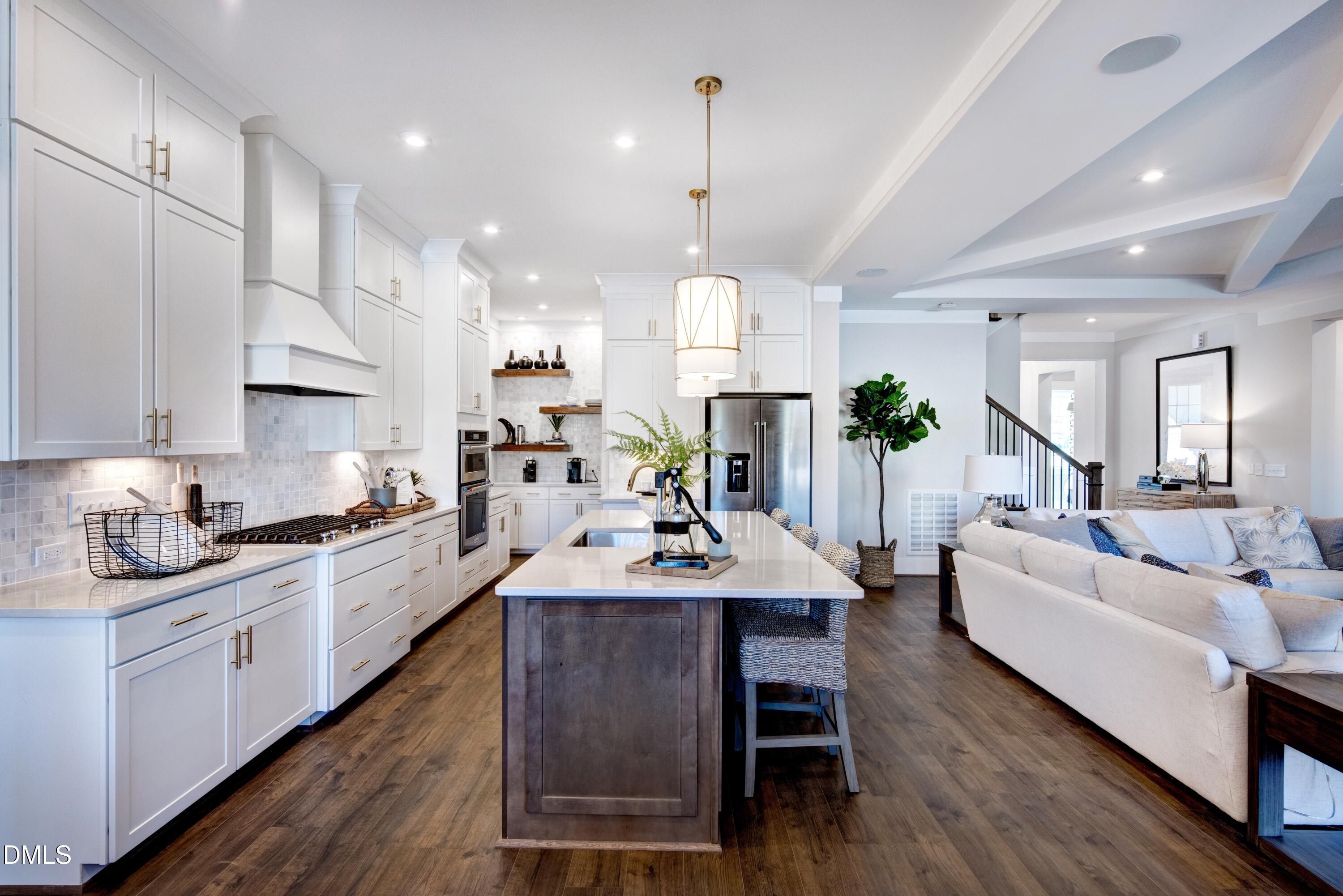3 Wolf Tree Way Efland, NC 27243 - Photo 5 of 32 a large kitchen with cabinets a sink a center island and stainless steel appliances