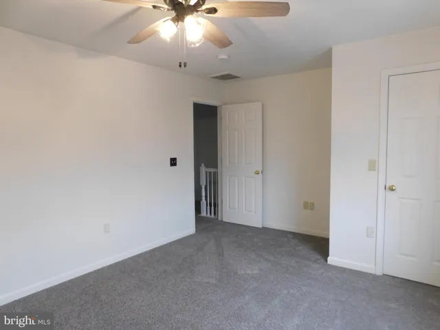 an empty room with a empty space and a ceiling fan