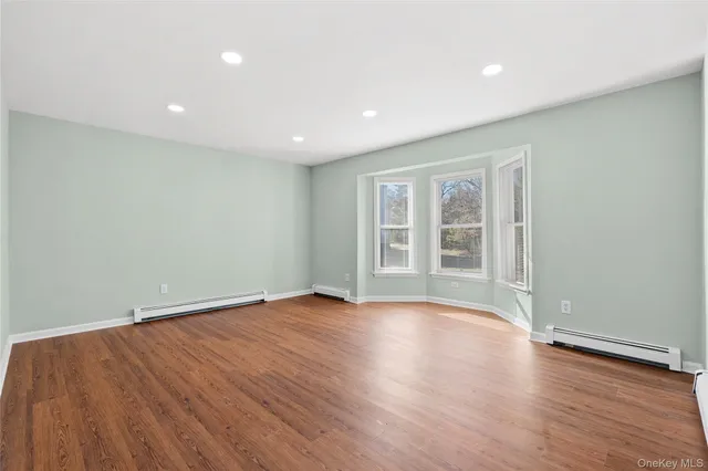 a large kitchen with stainless steel appliances granite countertop a stove a sink and a refrigerator