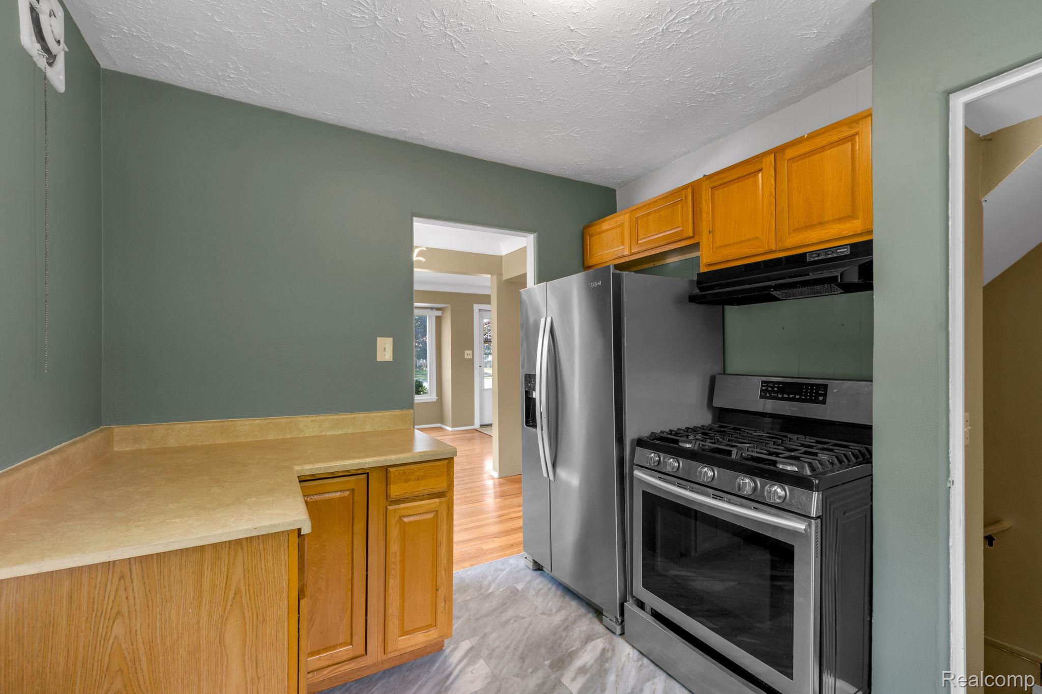 7641 Pelham Road Allen Park, MI 48101 - Photo 19 of 21 Kitchen with stainless steel appliances, wood-finish cabinetry, light-toned countertops, and recessed lighting