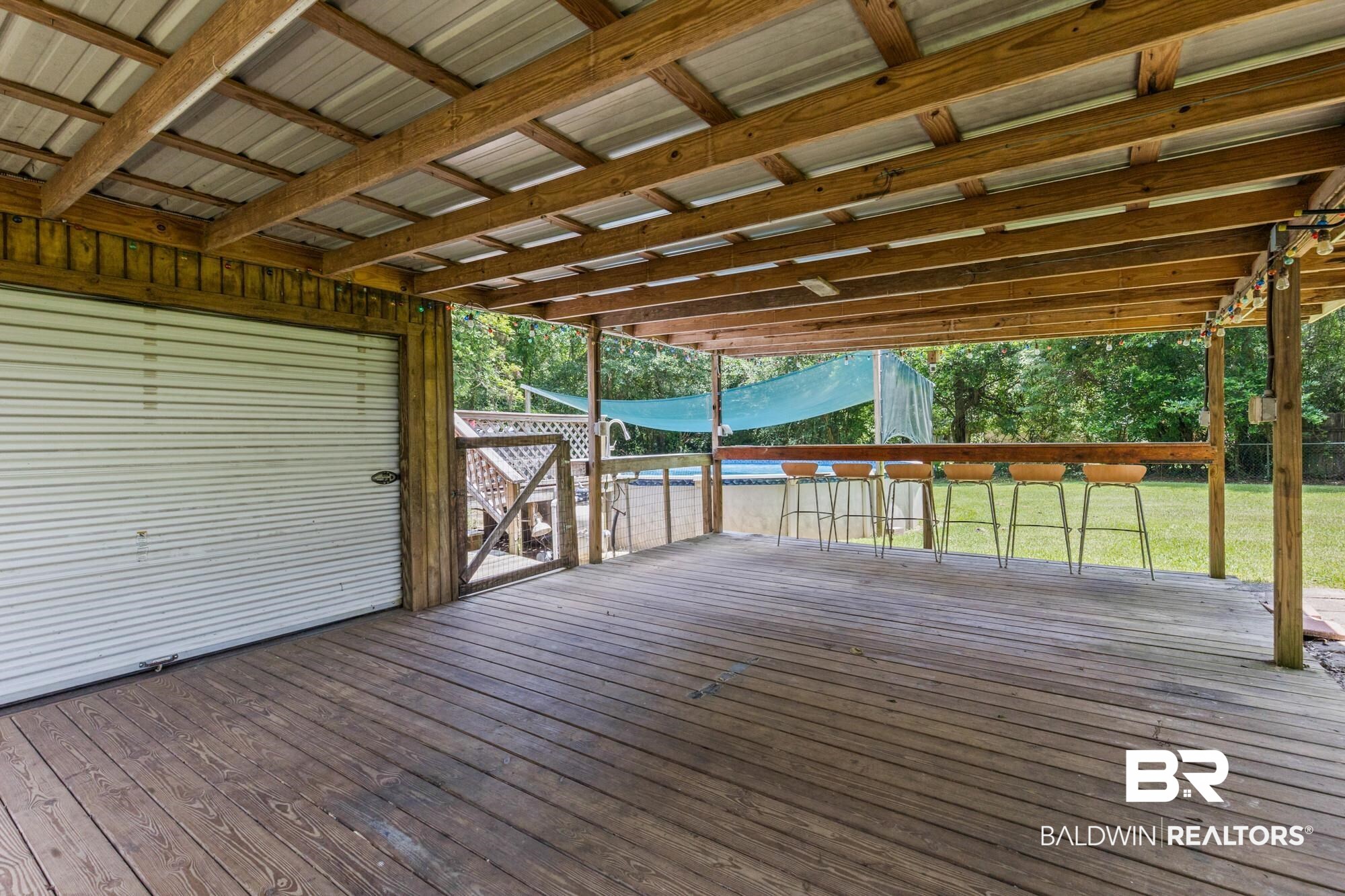 6933 Burbank Court Mobile, AL 36619 - Photo 6 of 25 Covered outdoor deck featuring natural wood flooring and exposed wood ceiling beams