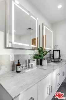 a kitchen with refrigerator and cabinets