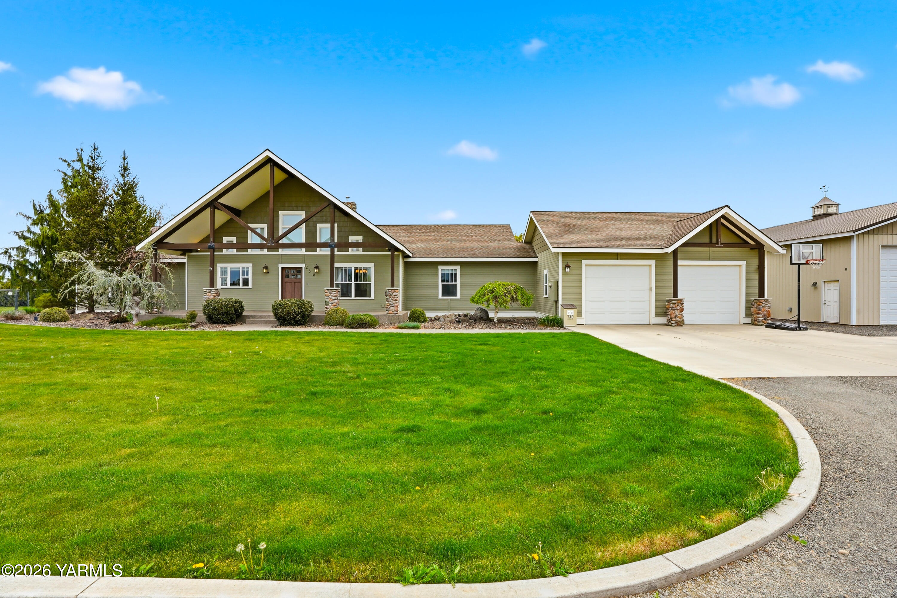 a front view of a house with a garden and yard