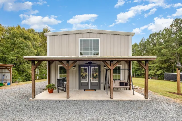 a view of a house with backyard porch and furniture