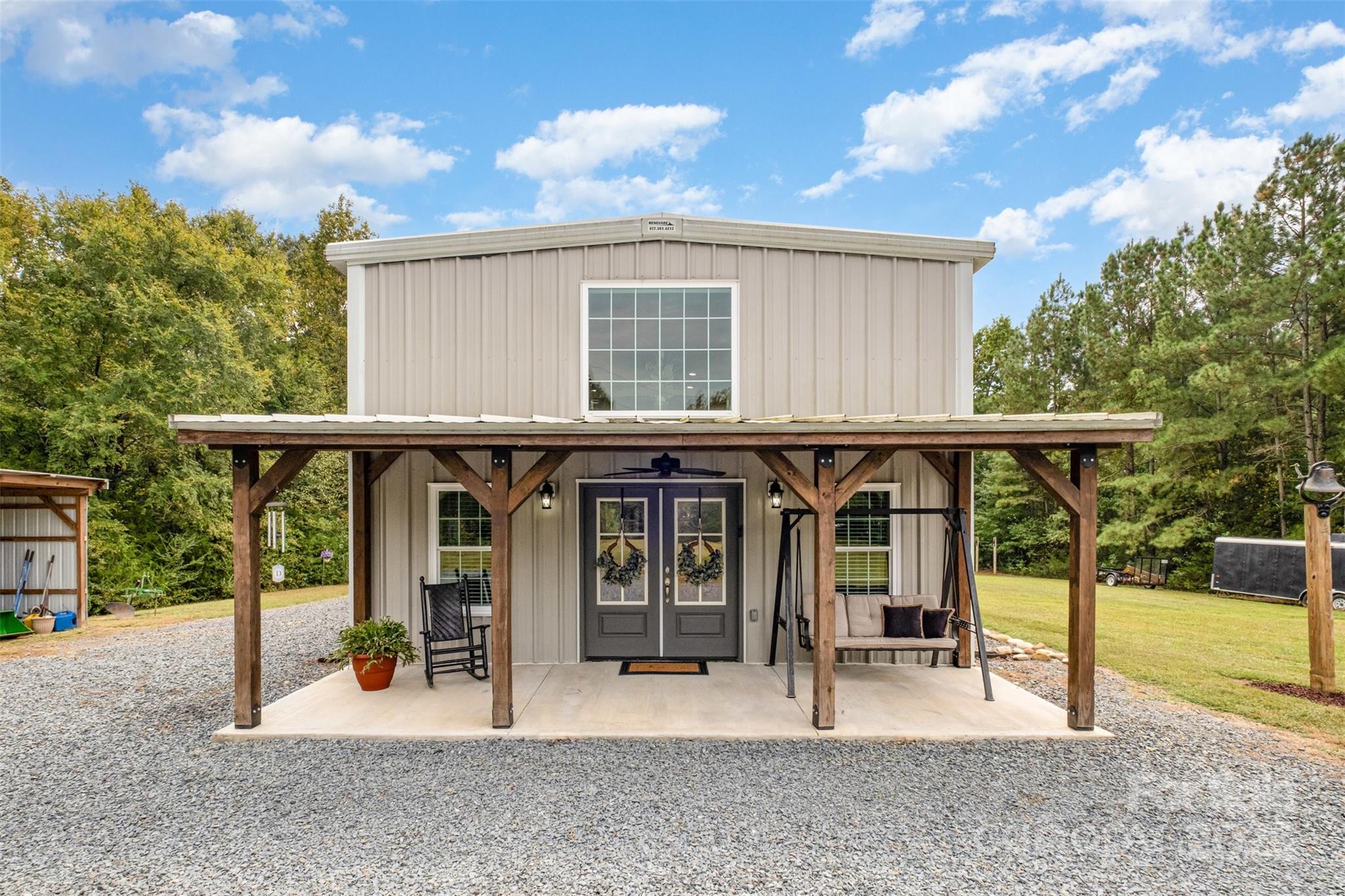a view of a house with backyard porch and furniture