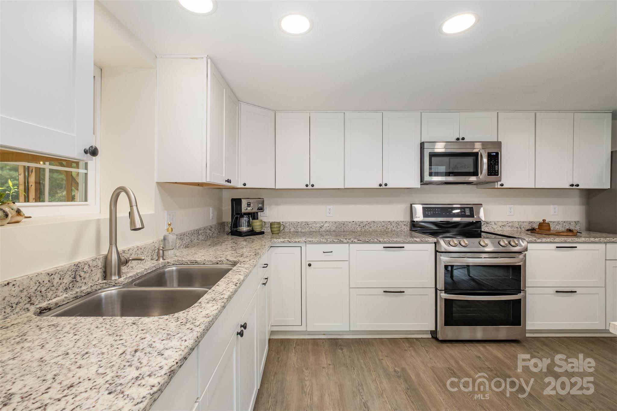690 Hill Road Wadesboro, NC 28170 - Photo 11 of 26 a kitchen with granite countertop a sink and a stove top oven