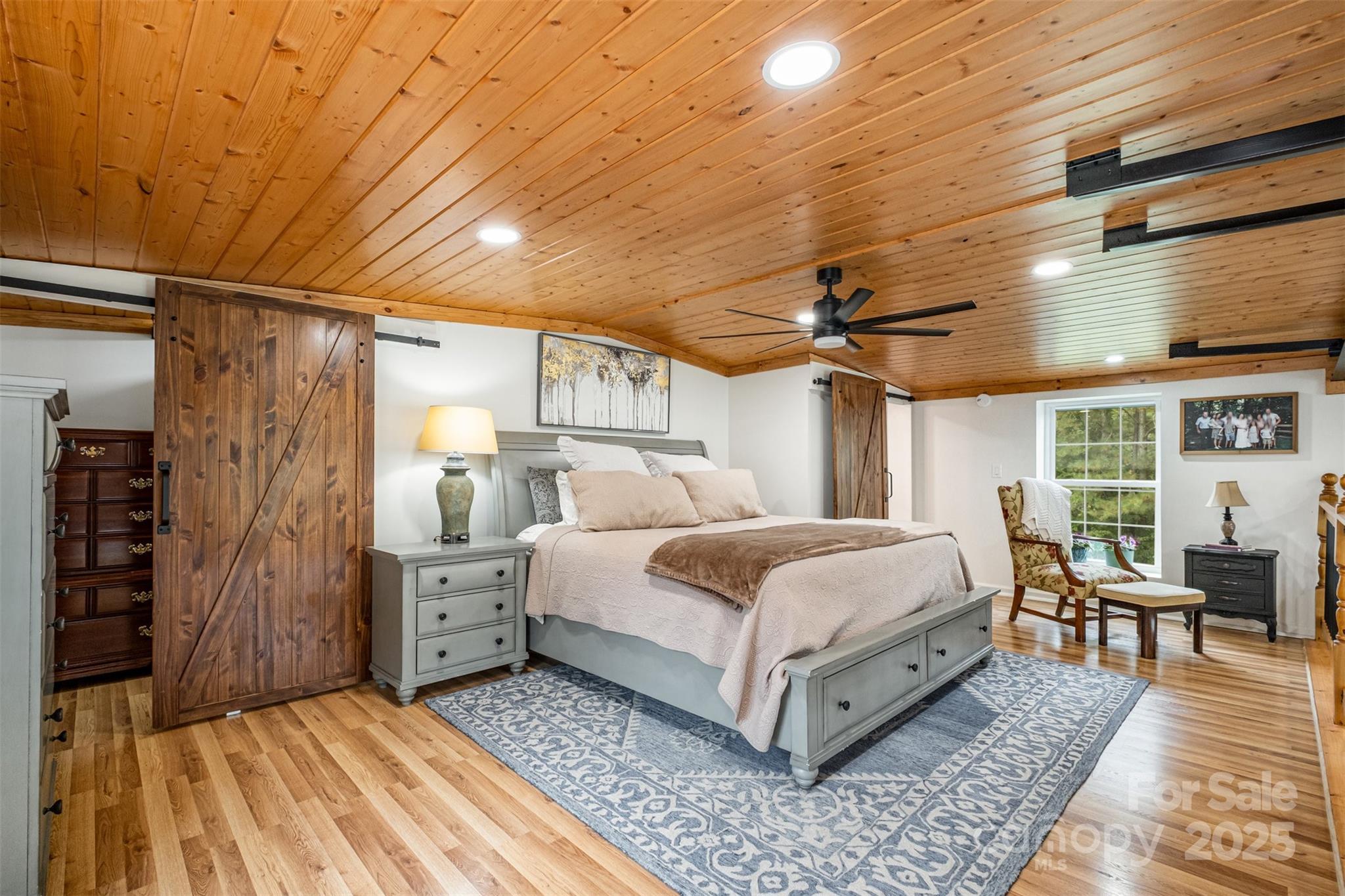 690 Hill Road Wadesboro, NC 28170 - Photo 13 of 26 a spacious bedroom with a bed a chandelier and closet