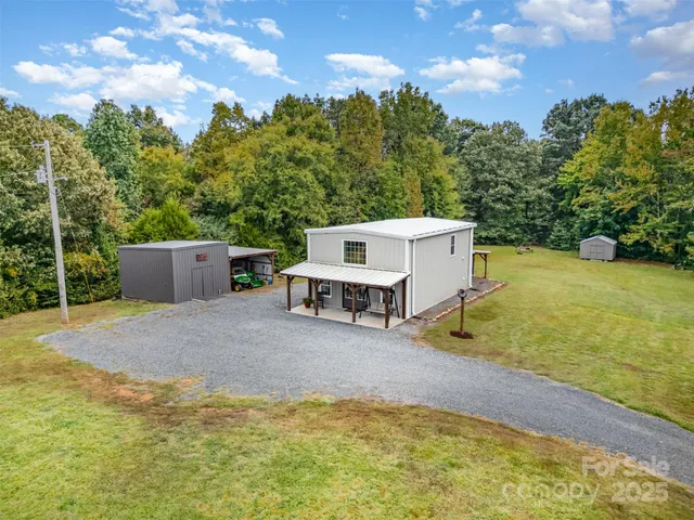 a view of a house with pool and a yard