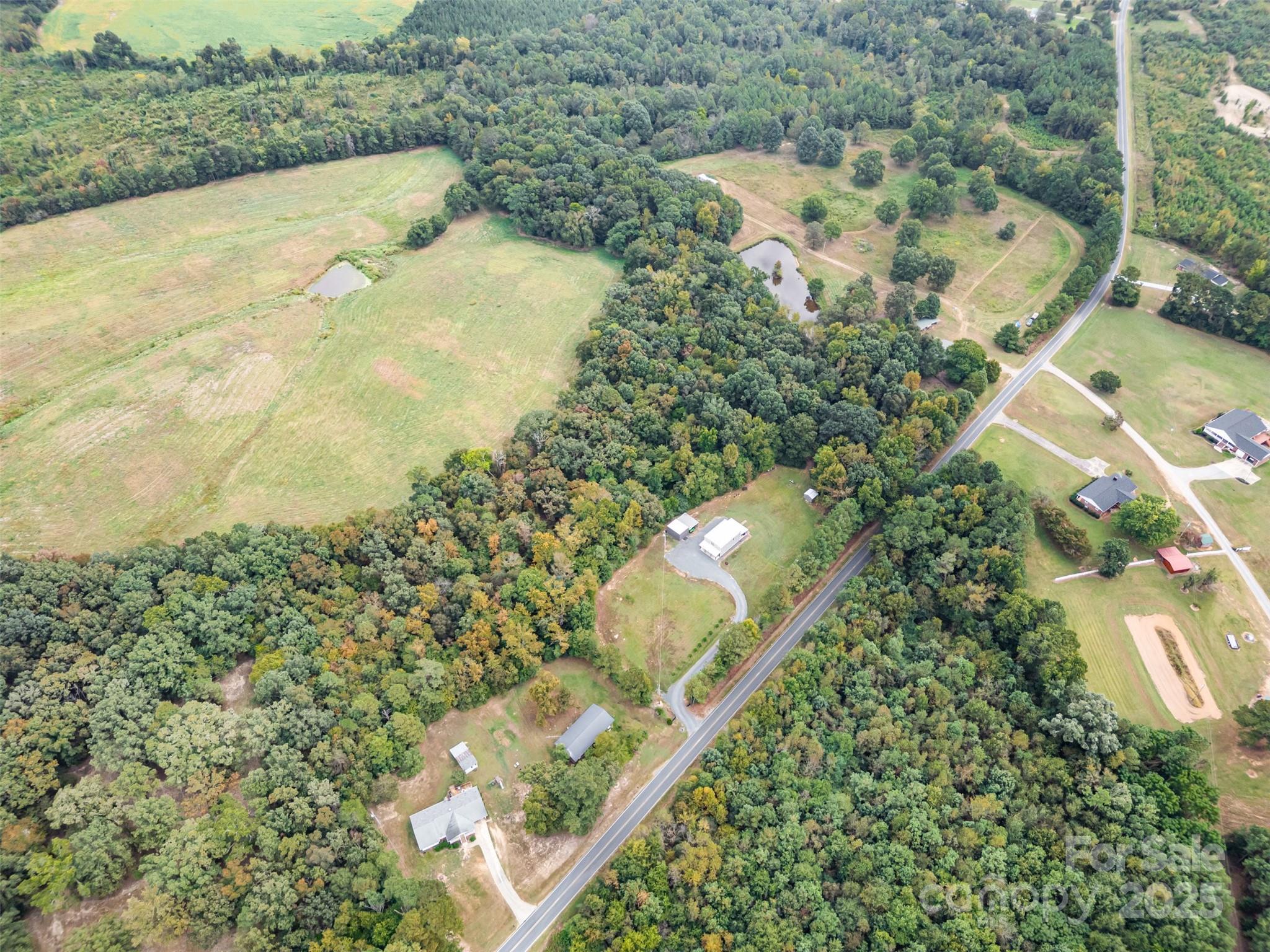 690 Hill Road Wadesboro, NC 28170 - Photo 22 of 26 an aerial view of a house with a yard and mountain view in back