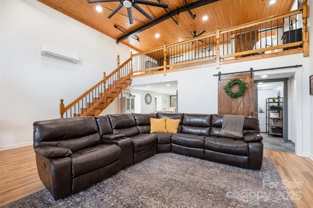 a living room with furniture a ceiling fan and a rug