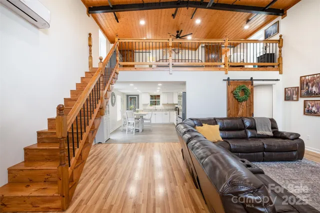 a living room with furniture or stairs and a wooden floor