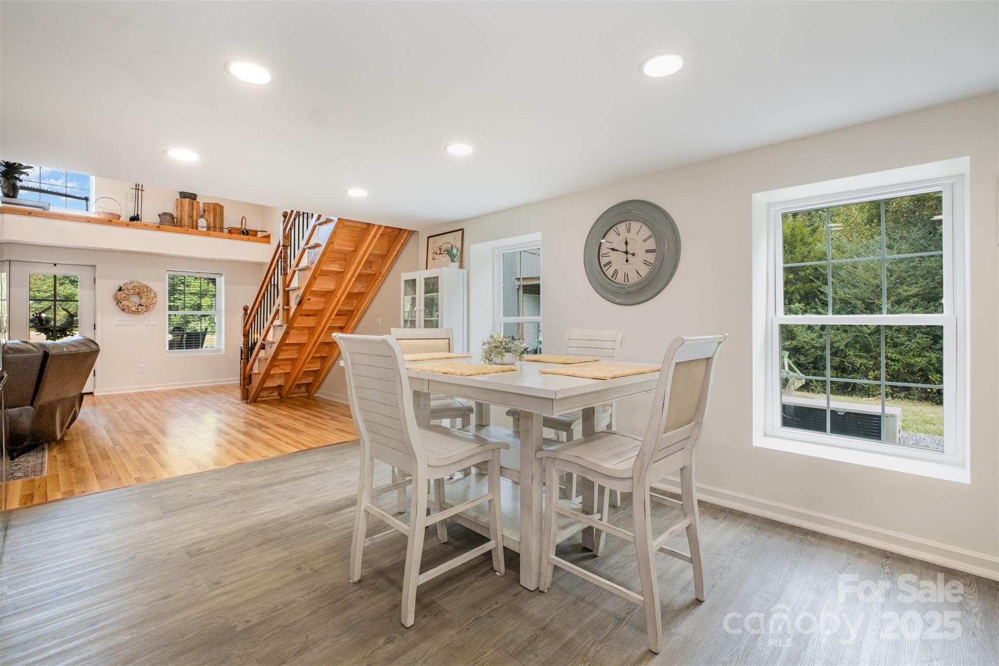 690 Hill Road Wadesboro, NC 28170 - Photo 8 of 26 a view of a dining room with furniture wooden floor and a clock