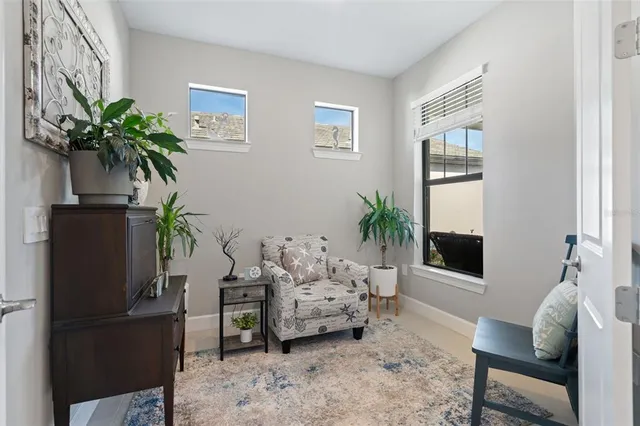a living room with furniture potted plant and a window