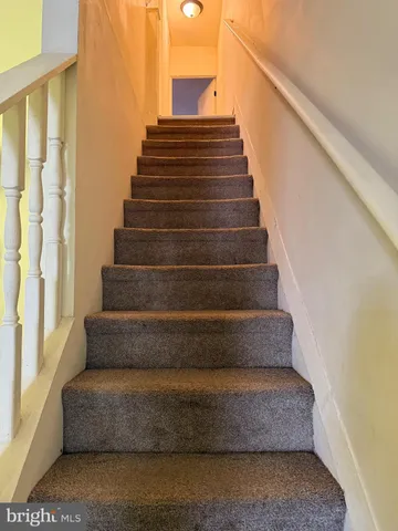 a view of staircase with white walls