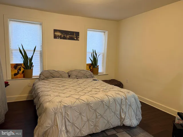 a bedroom with a bed and a wall painting